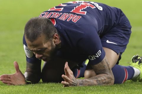 PSG's Dani Alves reacts during the French League One soccer match between Lyon and Paris Saint-Germain in Decines, near Lyon, central France, Sunday, Feb. 3, 2019. (AP Photo/Laurent Cipriani)