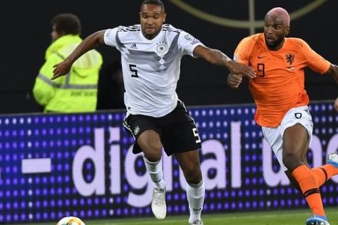 Germany's Jonathan Tah vies for the ball with Netherlands' Ryan Babel, right, during the Euro 2020 group C qualifying soccer match between Germany and the Netherlands at the Volksparkstadion in Hamburg, Germany, Friday, Sept. 6, 2019. (AP Photo/Martin Meissner)