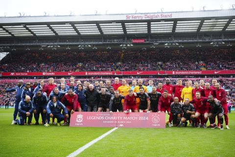 The teams pose for a group photo with former England manager Sven-Goran Eriksson, center left, before an exhibition soccer match between Liverpool Legends and Ajax Legends at Anfield Stadium, Liverpool, England, Saturday March 23, 2024. Former England boss Eriksson, who is a lifelong Liverpool fan, disclosed his terminal cancer diagnosis in January. (AP Photo/Jon Super)