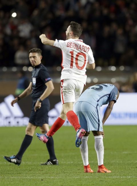 Manchester City's Fernandinho reacts while Monaco's Bernardo Silva jumps in the air in celebration at the end of a Champions League round of 16 second leg soccer match between Monaco and Manchester City at the Louis II stadium in Monaco, Wednesday March 15, 2017. Midfielder Tiemoue Bakayoko's thumping header sent Monaco through to the Champions League quarterfinals as the home side beat Manchester City 3-1 on Wednesday to progress on the away goals rule in another pulsating match between two attack-minded sides. (AP Photo/Claude Paris)