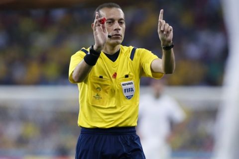 Referee Cuneyt Cakir gestures during the group H World Cup soccer match between Algeria and Russia at the Arena da Baixada in Curitiba, Brazil, Thursday, June 26, 2014. (AP Photo/Jon Super)