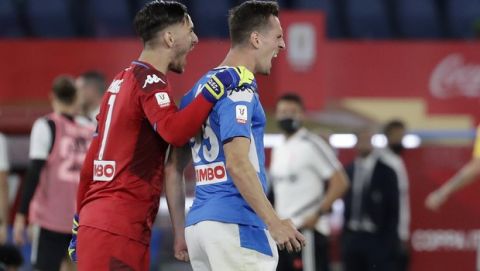 Napoli's Arkadiusz Milik, right, celebrates with his teammate Alex Meret after scoring the winning penalty during the Italian Cup soccer final match between Napoli and Juventus, at Rome's Olympic Stadium, Wednesday, June 17, 2020. (AP Photo/Andrew Medichini)