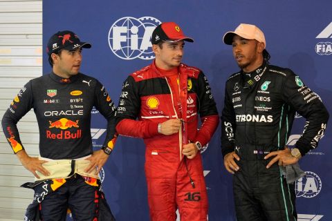 Ferrari driver Charles Leclerc of Monaco, center, who clocked the fastest time, talk with Red Bull driver Sergio Perez of Mexico, left, second fastest, and Mercedes driver Lewis Hamilton of Britain, right, third fastest, after the qualifying session at the Singapore Formula One Grand Prix, at the Marina Bay City Circuit in Singapore, Saturday, Oct. 1, 2022. (AP Photo/Vincent Thian)
