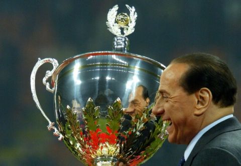 AC Milan's president Silvio Berlusconi holds the Cup after Berlusconi trophy between Juventus and AC Milan at San Siro Stadium in Milan, 06 January  2006. AC Milan beat Juventus 3-2. AFP PHOTO / GIUSEPPE CACACE