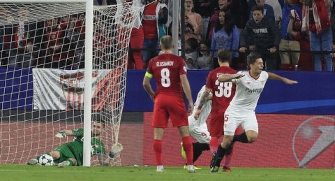 Sevilla's Clement Lenglet, right, celebrates scoring the opening goal during a Champions League group E soccer match between Sevilla and Spartak Moskva, at the Ramon Sanchez Pizjuan stadium in Seville, Spain, Wednesday, Nov. 1, 2017. (AP Photo/Miguel Morenatti)