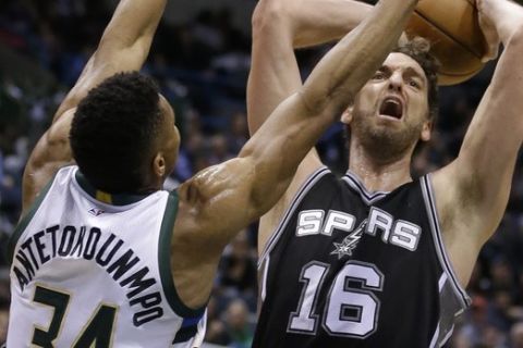 San Antonio Spurs' Pau Gasol (16) goes up for a shot against Milwaukee Bucks' Giannis Antetokounmpo during the second half of an NBA basketball game Monday, Dec. 5, 2016, in Milwaukee. The Spurs won, 97-96. (AP Photo/Aaron Gash) 