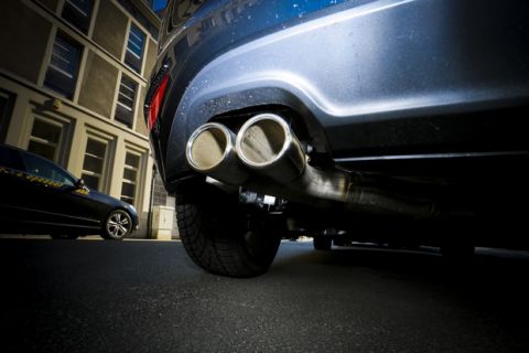 Automobile sector scandal crisis. Car industry manipulation exhaust test  stockhsots. Exhaust pipe close-up