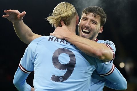 Manchester City's Erling Haaland is embraced by Ruben Dias, right, after scoring during the Champions League round of 16 second leg soccer match between Manchester City and RB Leipzig at the Etihad stadium in Manchester, England, Tuesday, March 14, 2023. (AP Photo/Dave Thompson)