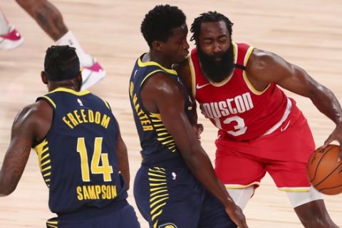 Houston Rockets guard James Harden (13) is defended by Indiana Pacers guard Victor Oladipo (middle) and forward JaKarr Sampson (14) in the second half of an NBA basketball game Wednesday, Aug. 12, 2020, in Lake Buena Vista, Fla. (Kim Klement/Pool Photo via AP)