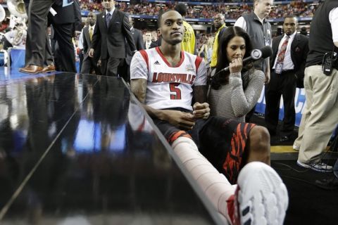 Louisville's Kevin Ware sits on the bench at the court before the first half of the NCAA Final Four tournament college basketball semifinal game against Wichita State, Saturday, April 6, 2013, in Atlanta. (AP Photo/David J. Phillip) 