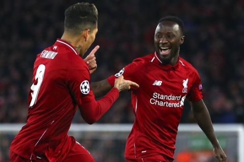Liverpool's Naby Keita celebrates with Roberto Firmino, left, after scoring the opening goal during the Champions League quarterfinal, first leg, soccer match between Liverpool and FC Porto at Anfield Stadium, Liverpool, England, Tuesday April 9, 2019. (AP Photo/Dave Thompson)