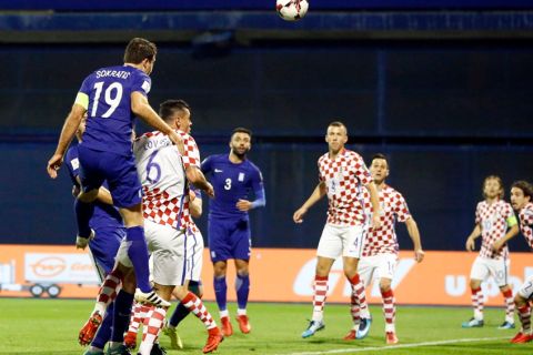 Greece's Sokratis Papastathopoulos (19) scores the opening goal of his team during the World Cup qualifying play-off first leg soccer match between Croatia and Greece at Maksimir Stadium in Zagreb, Thursday Nov. 9, 2017. (AP Photo/Darko Bandic)