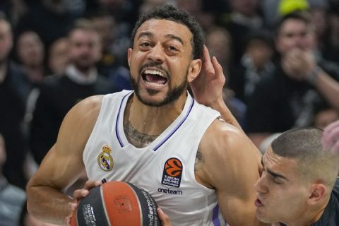 Real Madrid's Nigel Williams-Goss, left, drives to the basket as Partizan's Yam Madar tries to block him during the Euroleague basketball match between Partizan and Real Madrid, in Belgrade, Serbia, Tuesday, May 2, 2023. (AP Photo/Darko Vojinovic)