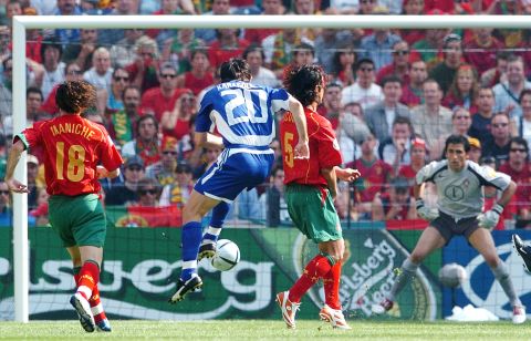 Georgios Karagounis of Greece (20) shoots to score past Portugal players Maniche, Fernando Couto and goalkeeper Ricardo (left to right), during their Euro 2004, Group A, soccer match at the Dragao stadium in Porto, Portugal, Saturday June 12, 2004. Other teams in group A are Spain and Russia. (AP Photo/Dusan Vranic)