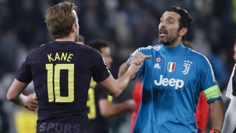 Juventus goalkeeper Gianluigi Buffon, right, greets Tottenham's Harry Kane at the end of the Champions League, round of 16, first-leg soccer match between Juventus and Tottenham Hotspurs, at the Allianz Stadium in Turin, Italy, Tuesday, Feb. 13, 2018. The match need in a 2-2 draw. (AP Photo/Antonio Calanni)