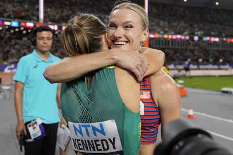 Katie Moon, of the United States, and Nina Kennedy, of Australia, left hug each other after sharing the gold medal in the Women's pole vault final during the World Athletics Championships in Budapest, Hungary, Wednesday, Aug. 23, 2023. (AP Photo/Matthias Schrader)