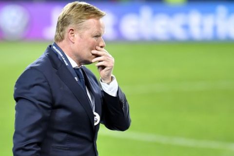 Netherlands coach Ronald Koeman walks in dejection after receiving his second place medal after the UEFA Nations League final soccer match between Portugal and Netherlands at the Dragao stadium in Porto, Portugal, Sunday, June 9, 2019. Portugal won 1-0. (AP Photo/Martin Meissner)