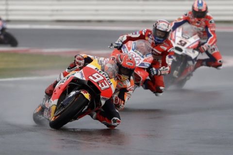 Moto GP rider Marc Marquez of Spain leads Andrea Dovizioso of Italy, Danilo Petrucci of Italy, right, and Maverick Vinales of Spain, left, during the San Marino Motorcycle Grand Prix at the Misano circuit in Misano Adriatico, Italy, Sunday, Sept. 10, 2017. (AP Photo/Antonio Calanni)