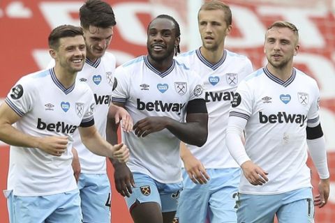 West Ham's Michail Antonio, center, celebrates after scoring his side's opening goal during the English Premier League soccer match between Manchester United and West Ham at the Old Trafford stadium in Manchester, England, Wednesday, July 22, 2020. (Martin Rickett/Pool via AP)