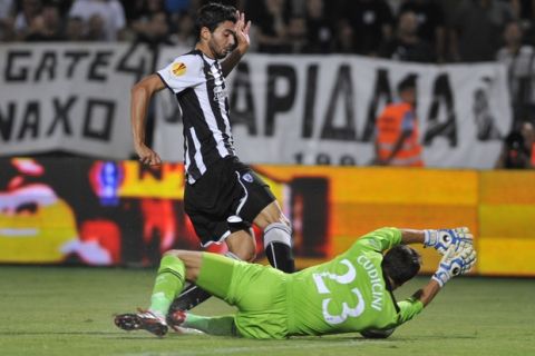 PAOK's Stefanos Athanasiadis, left, is blocked by Tottenham's goalie Carlo Cudicini during a UEFA Europa League soccer game in Thessaloniki, Greece, on Thursday Sept. 15, 2011. (AP Photo/Giorgos Nissiotis)
