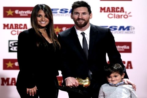 FC Barcelona's Lionel Messi poses with his wife Antonella Roccuzzo and their son Thiago after receiving his Golden Shoe award for leading all of Europe's leagues in scoring last season in Barcelona, Spain, Friday, Nov 24, 2017. Messi scored 37 goals in the Spanish league last season. It was the fourth time the Barcelona forward has received the honor. (AP Photo/Manu Fernandez)