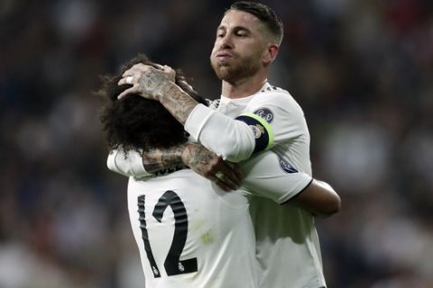 Real defender Marcelo, left, celebrates with Real defender Sergio Ramos after scoring his side's second goal during a Group G Champions League soccer match between Real Madrid and Viktoria Plzen at the Santiago Bernabeu stadium in Madrid, Spain, Tuesday Oct. 23, 2018. (AP Photo/Manu Fernandez)