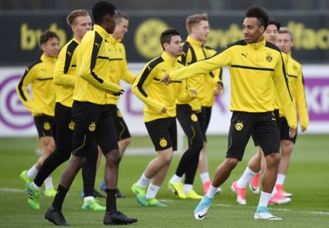 Dortmund's Pierre-Emerick Aubameyang, right, reacts to Ousmane Embele, left, during a training session prior the Champions League quarterfinal, first leg, soccer match between Borussia Dortmund and AS Monaco in Dortmund, Germany, Monday, April 10, 2017.  The match is on Tuesday in Dortmund. (AP Photo/Martin Meissner)