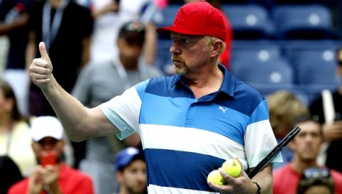 Boris Becker motions as he watches Novak Djokovic, of Serbia, practice after his opponent, Mikhail Youzhny, of Russia, retired in the first set of their match during the third round of the U.S. Open tennis tournament, Friday, Sept. 2, 2016, in New York. (AP Photo/Jason DeCrow)