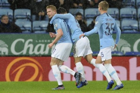 Manchester City's Kevin De Bruyne, left celebrates after scoring the opening goal the game during the English League Cup quarterfinal soccer match at the King Power stadium in Leicester, England, Tuesday, Dec.18, 2018. (AP Photo/Rui Vieira)