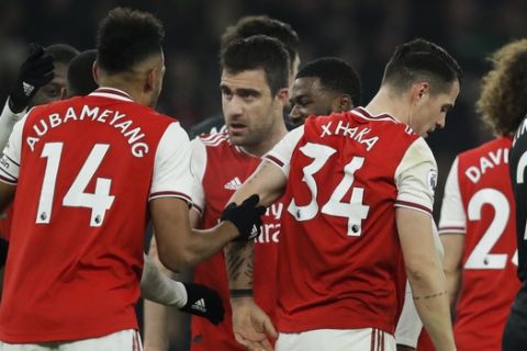 Arsenal's Sokratis Papastathopoulos, center, celebrates with teammates after scoring their side's second goal during the English Premier League soccer match between Arsenal and Manchester United at the Emirates Stadium in London, Wednesday, Jan. 1, 2020. (AP Photo/Matt Dunham)