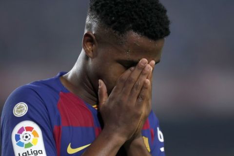 Barcelona's Ansu Fati covers his face during the Spanish La Liga soccer match between FC Barcelona and Valladolid CF at the Camp Nou stadium in Barcelona, Spain, Tuesday, Oct. 29, 2019. (AP Photo/Joan Monfort)