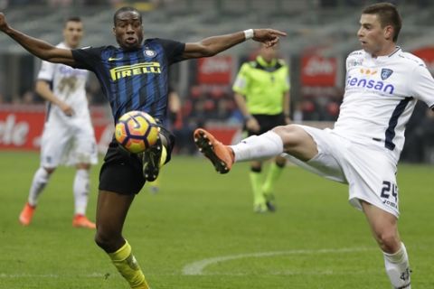 Inter Milan's Geoffrey Kondogbia, left, and Empoli's Uros Cosic vie for the ball during the Serie A soccer match between Inter Milan and Empoli at the San Siro stadium, in Milan, Italy, Sunday, Feb. 12, 2017. (AP Photo/Luca Bruno)