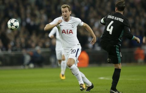 Tottenham's Harry Kane, left, dribbles past Real Madrid's Sergio Ramos during a Champions League Group H soccer match between Tottenham Hotspurs and Real Madrid at the Wembley stadium in London, Wednesday, Nov. 1, 2017. (AP Photo/Tim Ireland)