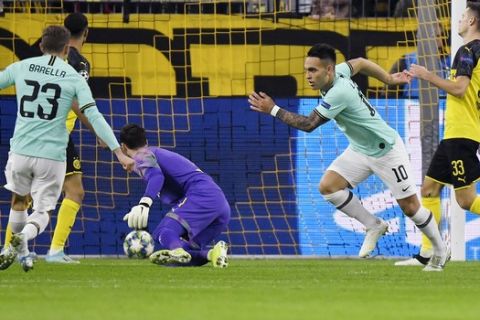 Inter Milan's Lautaro Martinez, second from right, celebrates after scoring his side's opening goal during the Champions League group F soccer match between Borussia Dortmund and Inter Milan, in Dortmund, Germany, Tuesday, Nov. 5, 2019. (AP Photo/Martin Meissner)