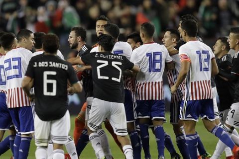 Soccer players from Mexico and Paraguay fight on the field during the second half of an international friendly soccer match Tuesday, March 26, 2019, in Santa Clara, Calif. (AP Photo/Ben Margot)
