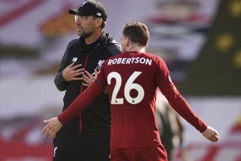 Liverpool's manager Jurgen Klopp, and Liverpool's Andrew Robertson reacts as they walk from the pitch after the end of the English Premier League soccer match between Liverpool and Burnley at Anfield, Liverpool, England, Saturday, July 11, 2020. The game ended in a 1-1 draw, Robertson scoring the Liverpool goal. (Oli Scarff/ Pool via AP)