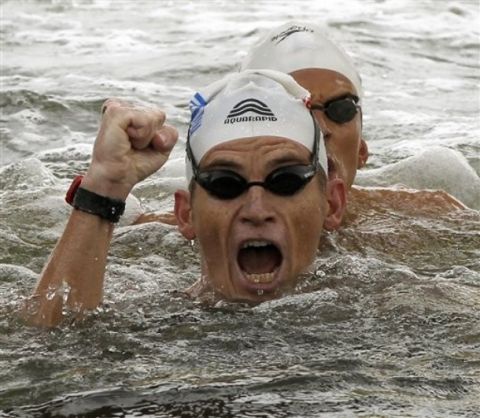Greece's Spyros Gianniotis celebrates after winning the Men's 10km Open Water swimming event at the FINA Swimming World Championships at Jinshan Beach in Shanghai, China, Wednesday, July 20, 2011.  The Greek swimmer finished in 1 hour, 54 minutes, 24.7 seconds. (AP Photo/Ng Han Guan)