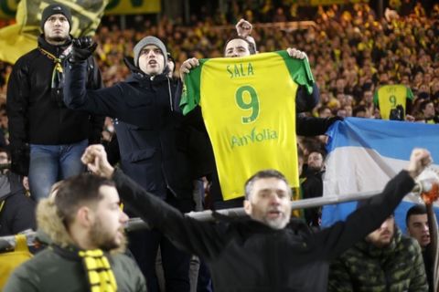Nantes supporters show a jersey in a tribute to to Argentinian player Emiliano Sala after the French League One soccer match Nantes against Saint-Etienne at La Beaujoire stadium in Nantes, western France, Wednesday, Jan.30, 2019. Sala disappeared over the English Channel on Jan. 21, 2019 as it flew from France to Wales. Sala had just been signed by Premier League club Cardiff. (AP Photo/Thibault Camus)