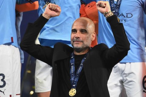 Manchester City's Spanish manager Pep Guardiola celebrates with the winners' medal after winning the UEFA Champions League final football match between Inter Milan and Manchester City at the Ataturk Olympic Stadium in Istanbul, on June 10, 2023. (Photo by FRANCK FIFE / AFP)