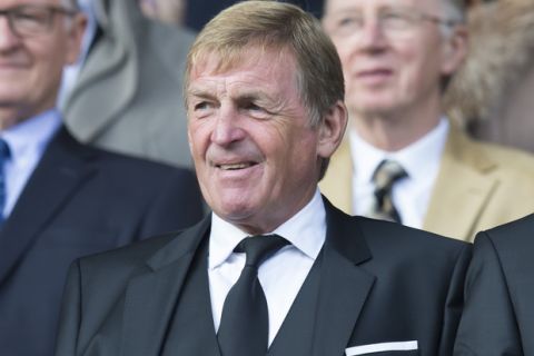 Former Liverpool manager Kenny Dalglish, centre, takes his seat before the English Premier League soccer match between Everton and Liverpool at Goodison Park Stadium, Liverpool, England, Sunday Oct. 4, 2015. After the game it emerged that Liverpool have sacked their current manager Brendan Rodgers with immediate effect. (AP Photo/Jon Super)  