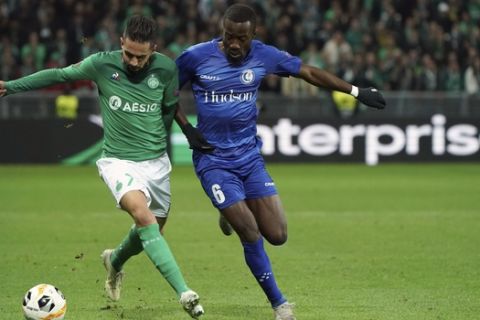 Saint-Etienne's Ryad Boudebouz, left, duels for the ball with Gent's Elisha Owusu during the Europa League group I soccer match between Saint Etienne and Gent at Geoffroy Guichard stadium in Saint Etienne, central France, Thursday, Nov. 28, 2019. (AP Photo/Laurent Cipriani)