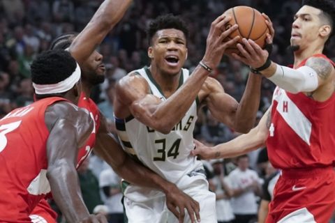 Milwaukee Bucks' Giannis Antetokounmpo tries to drive in traffic during the first half of Game 5 of the NBA Eastern Conference basketball playoff finals against the Toronto Raptors Thursday, May 23, 2019, in Milwaukee. (AP Photo/Morry Gash)
