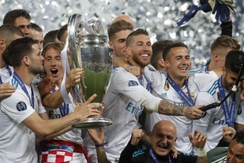 Real Madrid's Sergio Ramos takes a selfie while celebrating with the trophy after winning the Champions League Final soccer match between Real Madrid and Liverpool at the Olimpiyskiy Stadium in Kiev, Ukraine, Saturday, May 26, 2018. (AP Photo/Efrem Lukatsky)