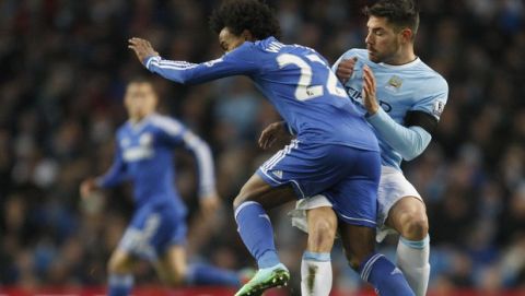 Manchester City's David Silva, right, collides with Chelsea's Willian during their English FA Cup fifth round soccer match at the Etihad Stadium, Manchester, England, Saturday, Feb. 15, 2014. (AP Photo/Jon Super)  