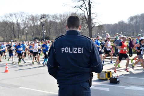 Un agente de la policía vigila durante el medio maratón de Berlín, el domingo 8 de abril de 2018. (Paul Zinken/dpa via AP)
