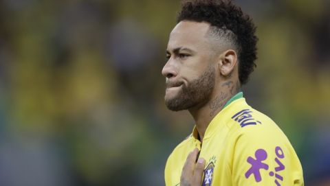 Brazil's Neymar puts his hand over his chest during the national anthem, prior a friendly soccer match against Qatar at the Estadio Nacional in Brasilia, Brazil, Wednesday, June 5, 2019.(AP Photo/Andre Penner)