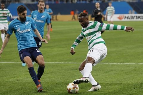 Celtic's Moussa Dembele, right, competes for the ball with Zenit's Miha Mevlja during the Europa League round of 32 second leg soccer match between Zenit St. Petersburg and Celtic at the Saint Petersburg stadium, in St. Petersburg, Russia, Thursday, Feb. 22, 2018. (AP Photo/Pavel Golovkin)