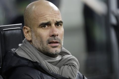 Manchester City's head coach Pep Guardiola sits on the bench prior to the start of the Champions League group C soccer match between Atalanta and Manchester City at the San Siro stadium in Milan, Italy, Wednesday, Nov. 6, 2019. (AP Photo/Luca Bruno)