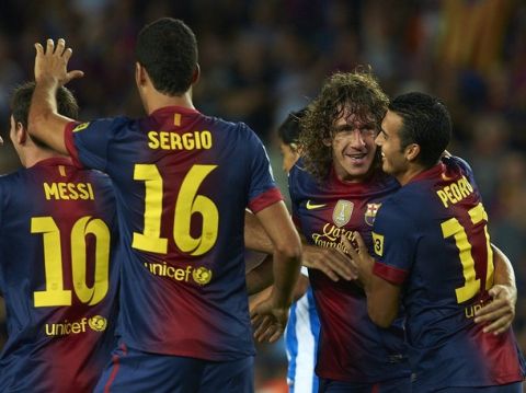 FC Barcelona's Carles Puyol, second right, celebrates his goal during a Spanish La Liga soccer match against Real Sociedad at the Camp Nou stadium in Barcelona, Spain, Sunday, Aug. 19, 2012. (AP Photo/Siu Wu)