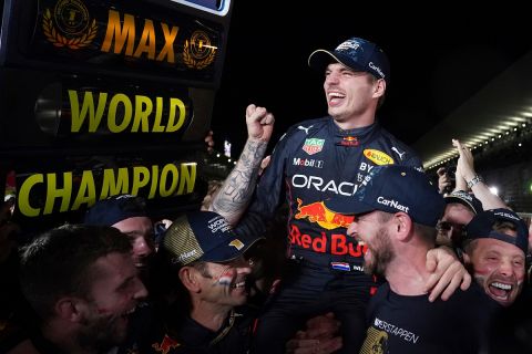 Red Bull driver Max Verstappen of the Netherlands celebrates with teammates as he became F1 drivers world champion, during the Japanese Formula One Grand Prix at the Suzuka Circuit in Suzuka, central Japan, Sunday, Oct. 9, 2022. (AP Photo/Toru Hanai)